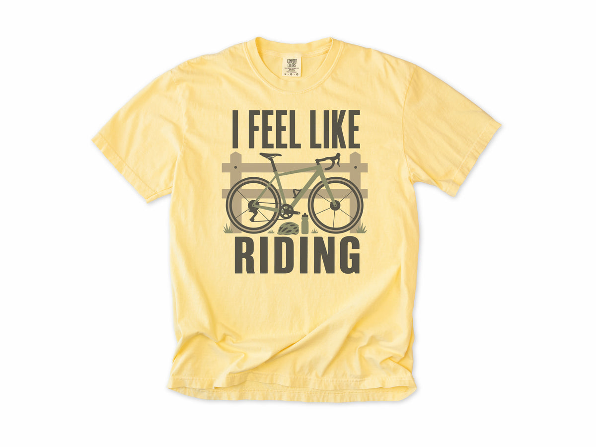 Cycling T-shirt in Butter, 'I Feel Like Riding' with a bike on a wooden fence, for road and gravel cyclists