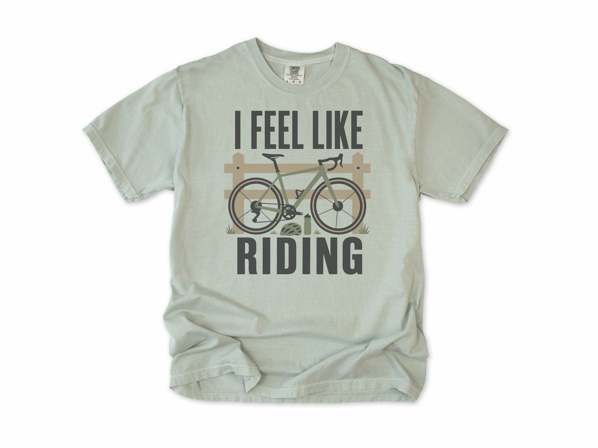 Cycling T-shirt in Bay, 'I Feel Like Riding' with a bike on a wooden fence, for road and gravel cyclists