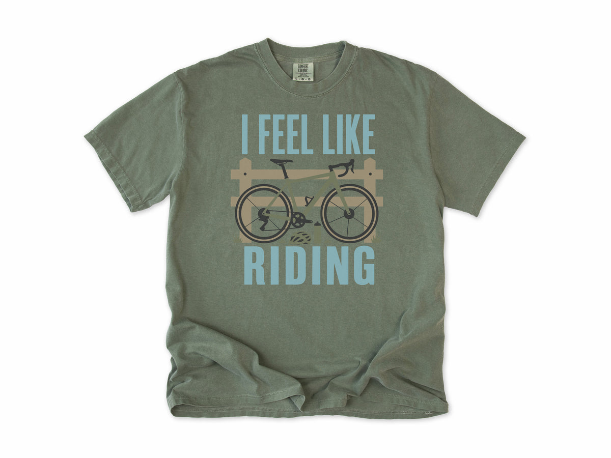 Cycling T-shirt in Moss, 'I Feel Like Riding' with a bike on a wooden fence, for road and gravel cyclists