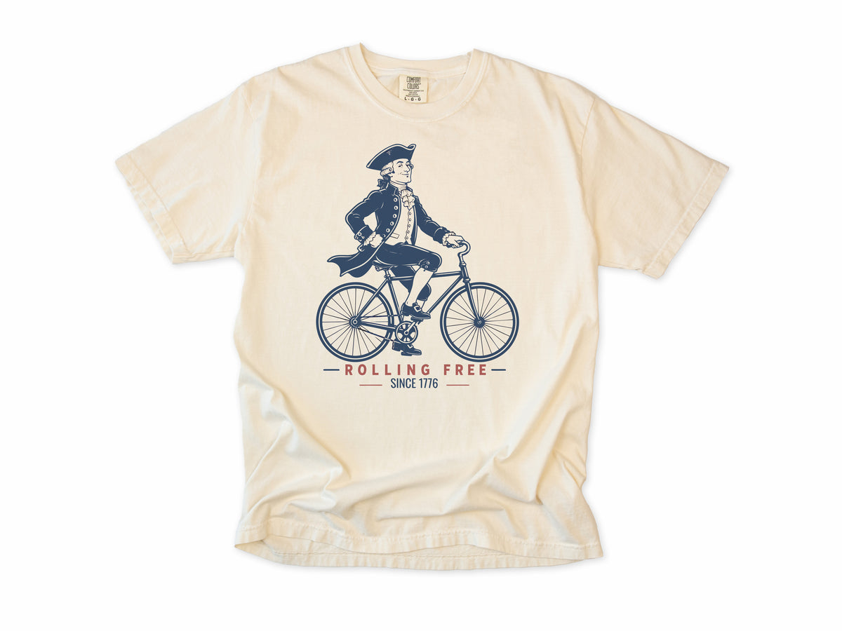 Cycling T-shirt in Ivory, Founding Father: a colonial gentleman in a tricorn hat riding a bike, America 250 and 4th of July gift for cyclists