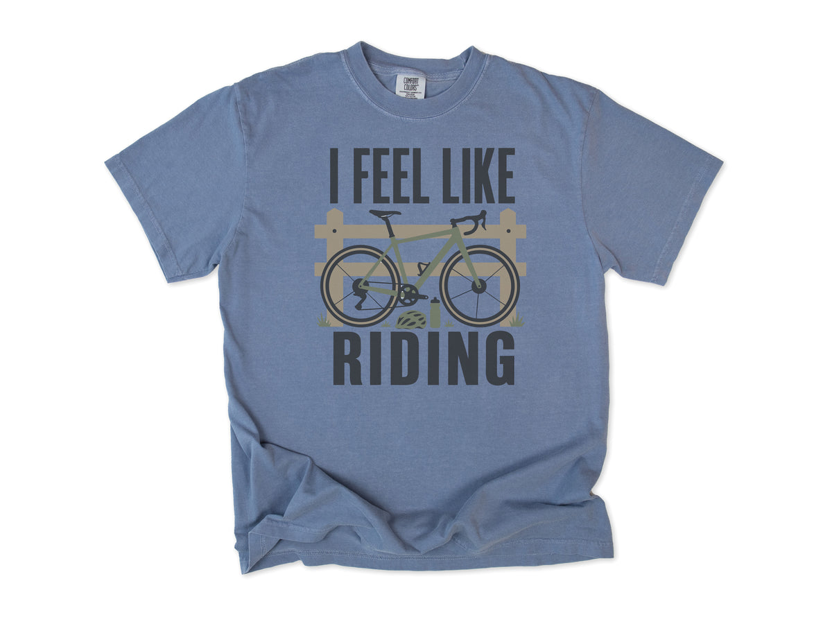 Cycling T-shirt in Blue Jean, 'I Feel Like Riding' with a bike on a wooden fence, for road and gravel cyclists