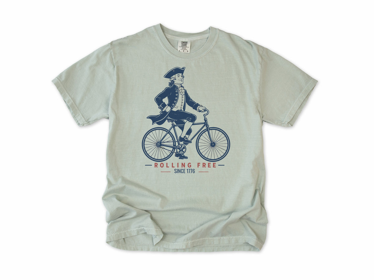Cycling T-shirt in Bay, Founding Father: a colonial gentleman in a tricorn hat riding a bike, America 250 and 4th of July gift for cyclists