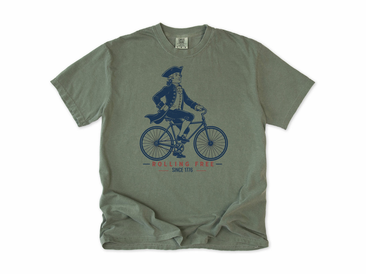 Cycling T-shirt in Moss, Founding Father: a colonial gentleman in a tricorn hat riding a bike, America 250 and 4th of July gift for cyclists