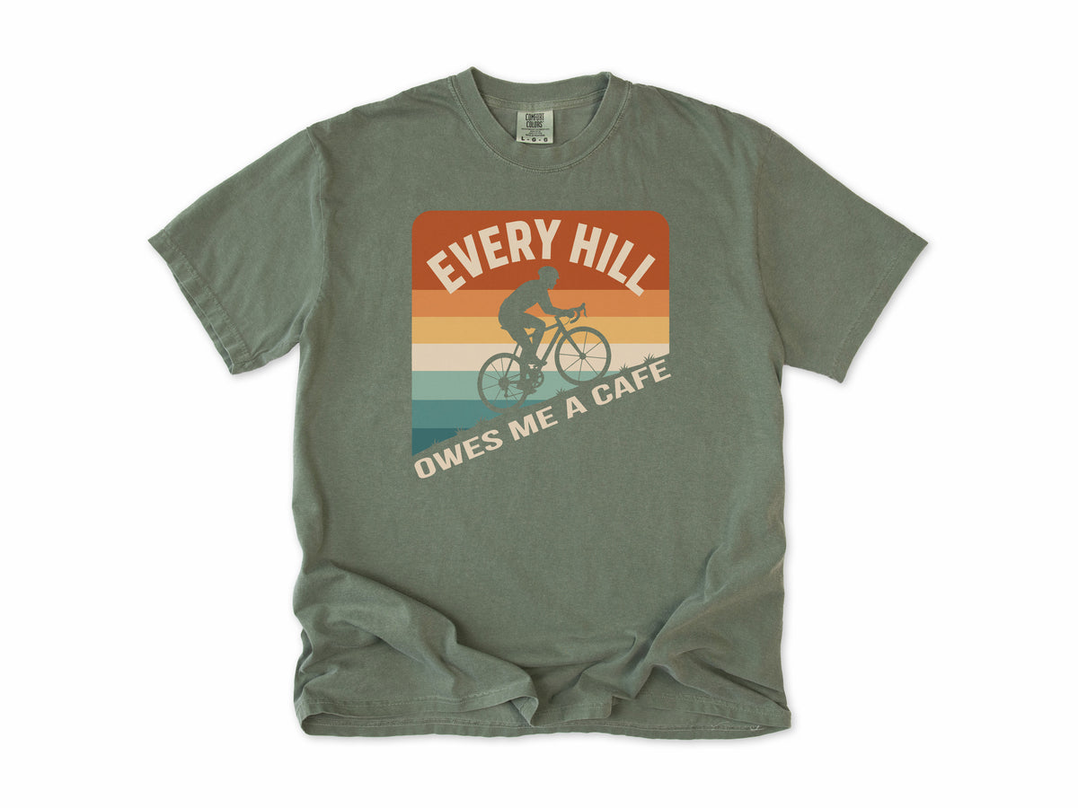 Funny cycling T-shirt in Moss, 'Every Hill Owes Me a Cafe', a cyclist on retro stripes, for riders who ride for coffee