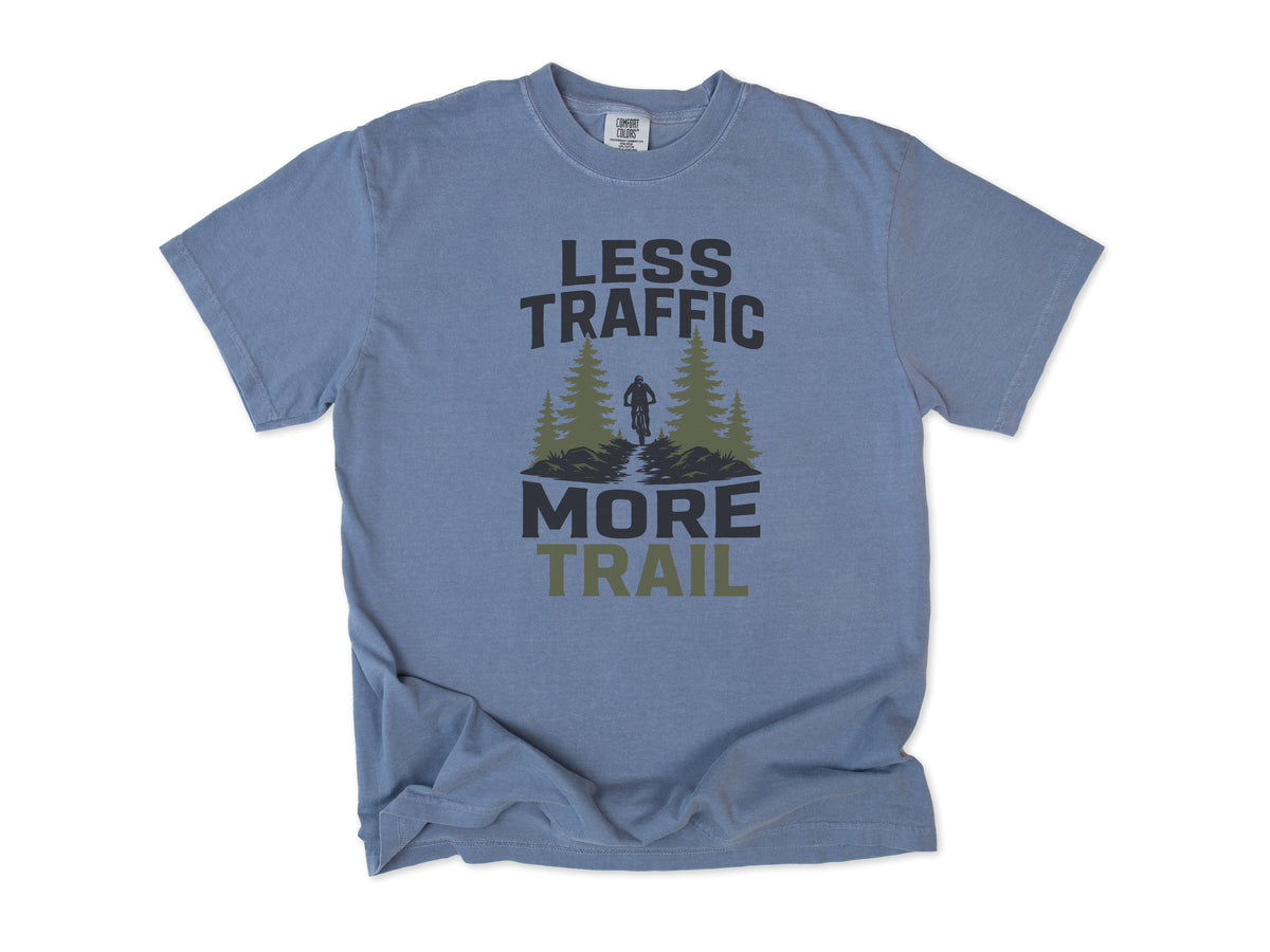 Cycling T-shirt in Blue Jean, 'Less Traffic More Trail' with a rider between pine trees, for mountain bikers