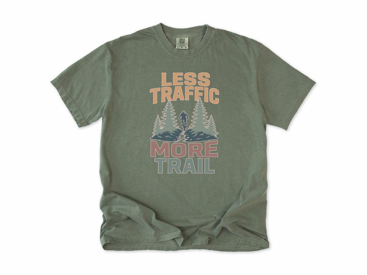 Cycling T-shirt in Moss, 'Less Traffic More Trail' with a rider between pine trees, for mountain bikers