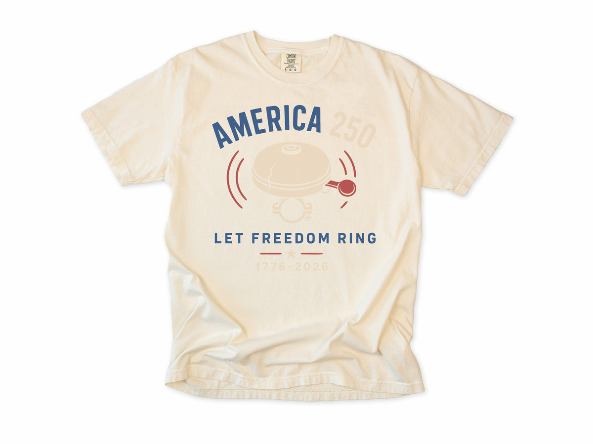 Cycling T-shirt in Ivory, a bike bell with 'Let Freedom Ring', America 250 and 4th of July gift for cyclists