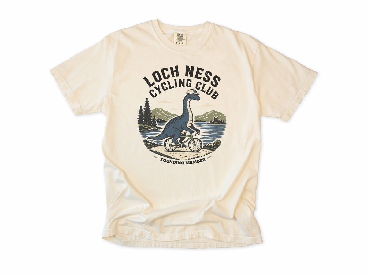 Cycling T-shirt in Ivory, 'Loch Ness Cycling Club', a monster riding a bike by a loch, for cycling club members