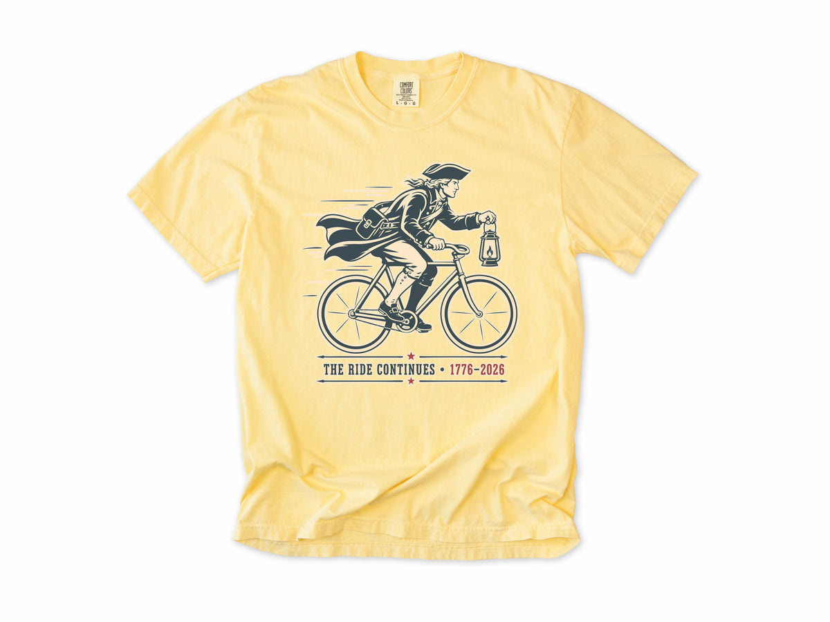 Cycling T-shirt in Butter, Midnight Ride: a colonial rider with a lantern on a bike, America 250 and 4th of July gift for cyclists