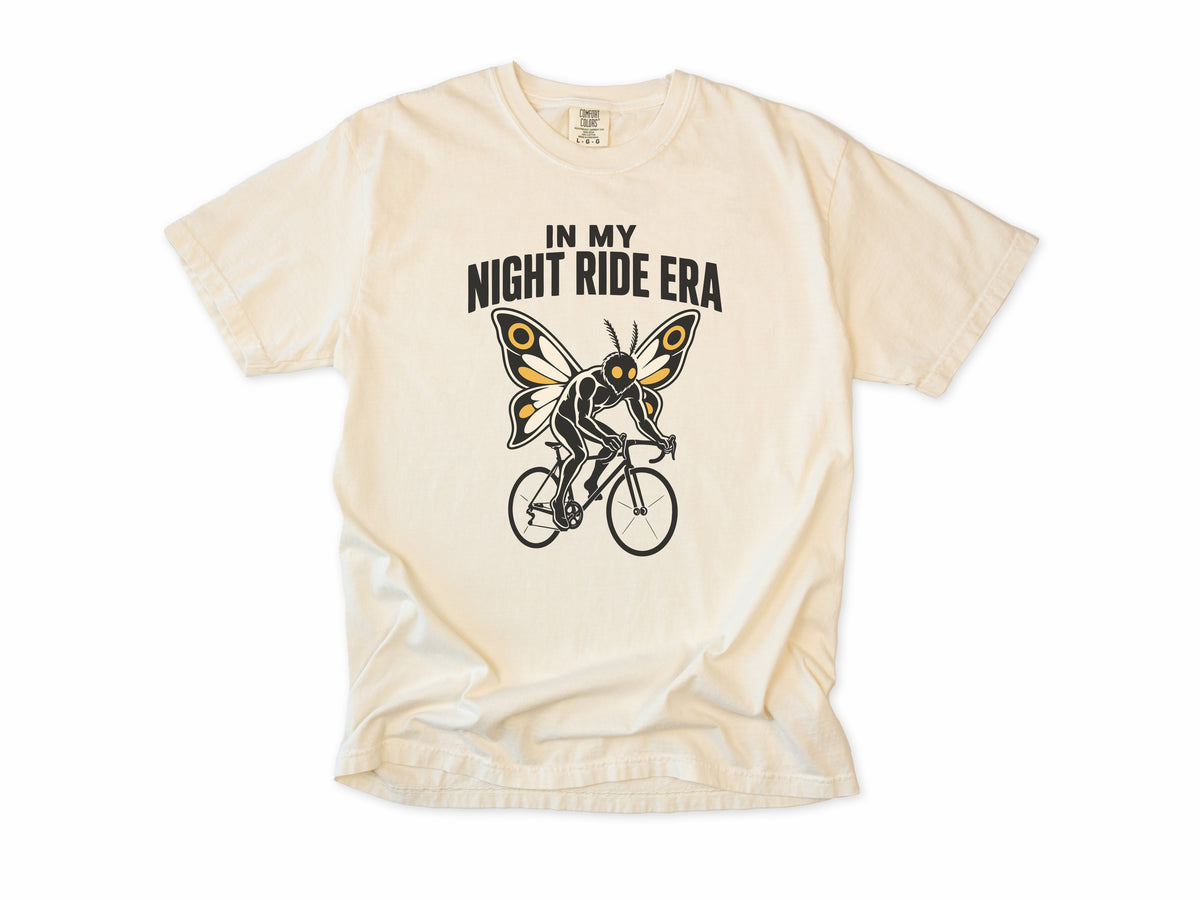 Funny cycling T-shirt in Ivory, Mothman Single: 'In my night ride era', a moth-winged figure riding a bike, for night riders