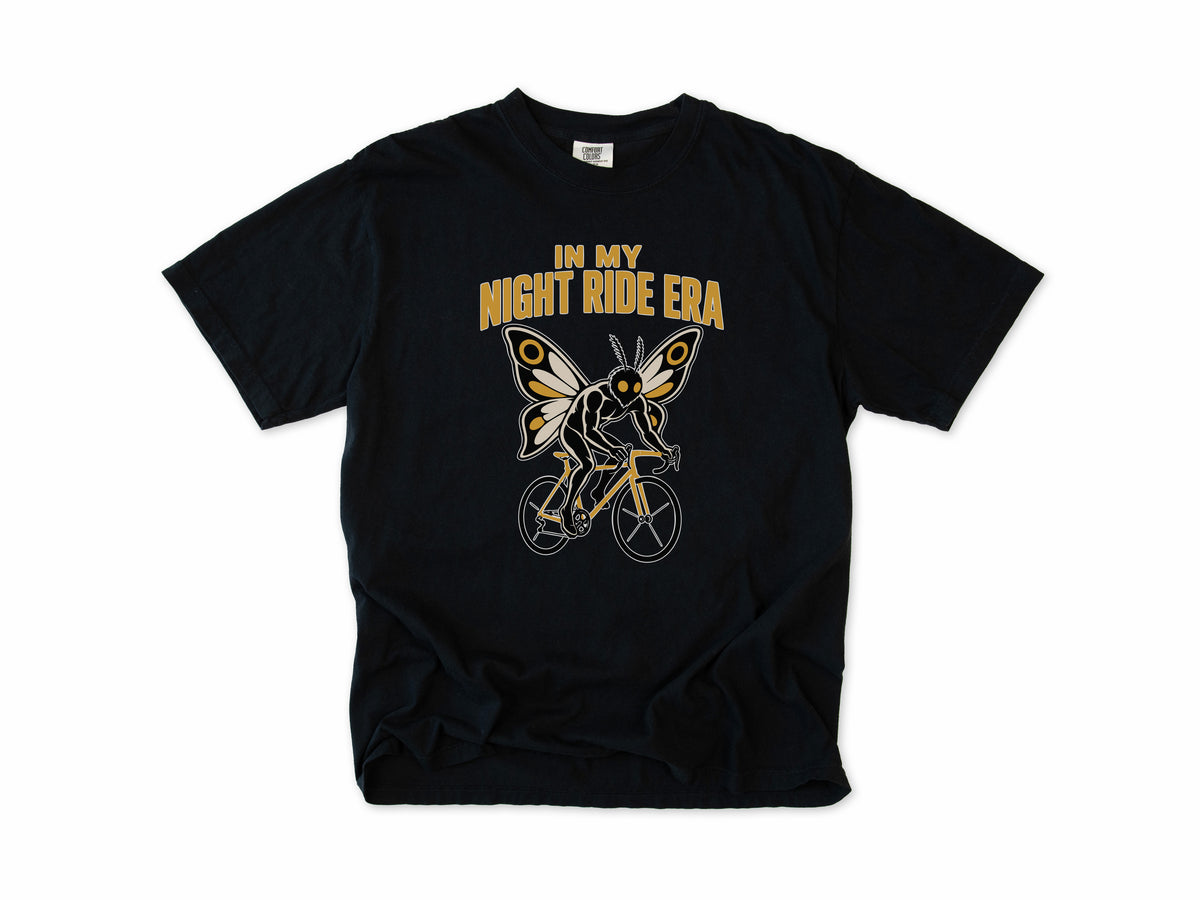 Funny cycling T-shirt in Black, Mothman Single: 'In my night ride era', a moth-winged figure riding a bike, for night riders