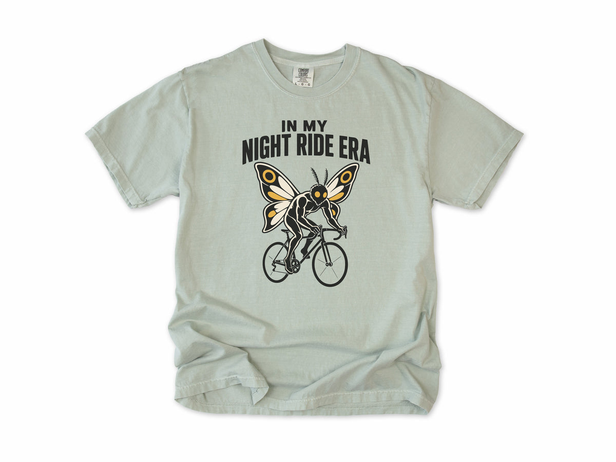 Funny cycling T-shirt in Bay, Mothman Single: 'In my night ride era', a moth-winged figure riding a bike, for night riders
