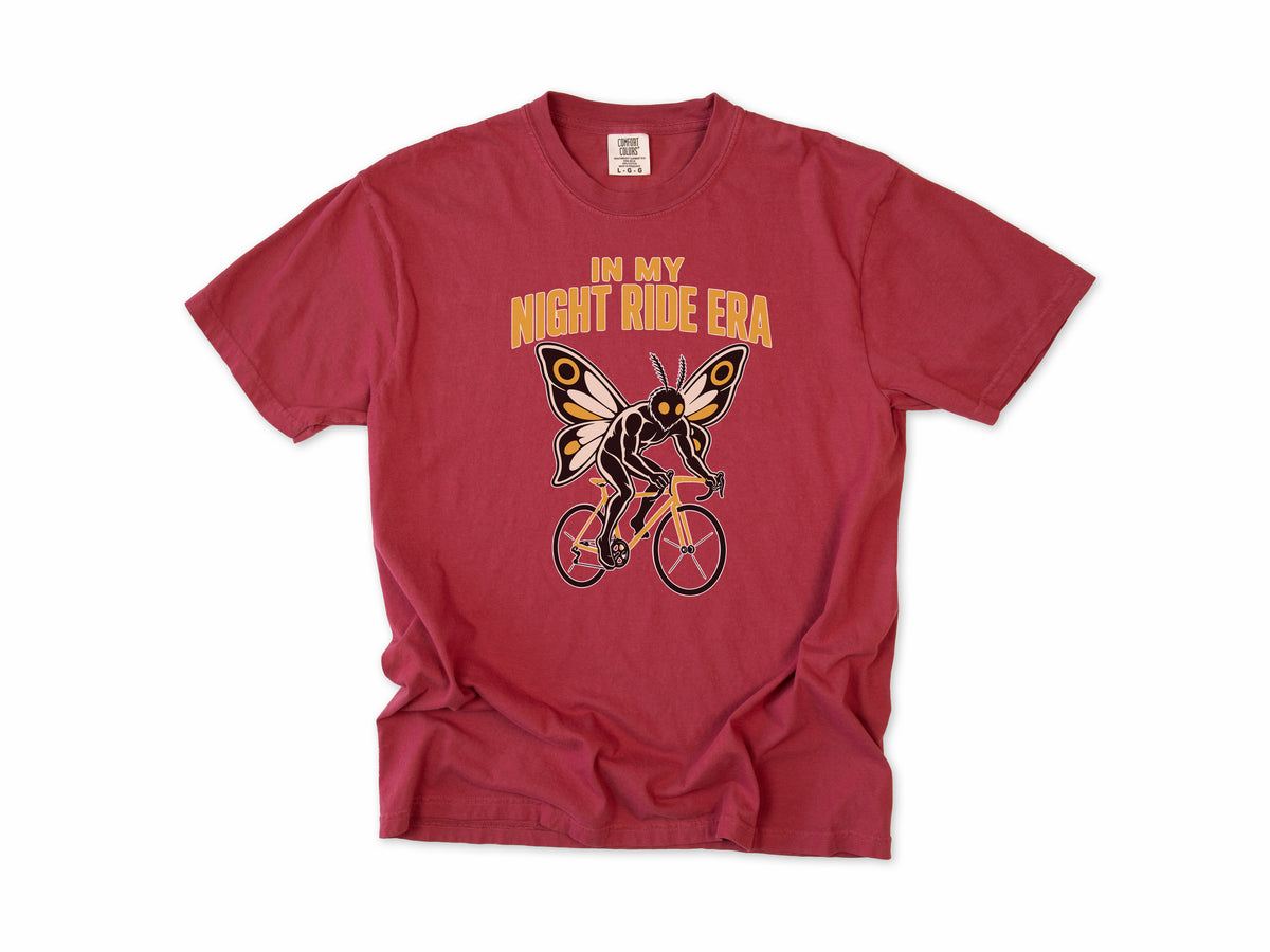 Funny cycling T-shirt in Chili, Mothman Single: 'In my night ride era', a moth-winged figure riding a bike, for night riders