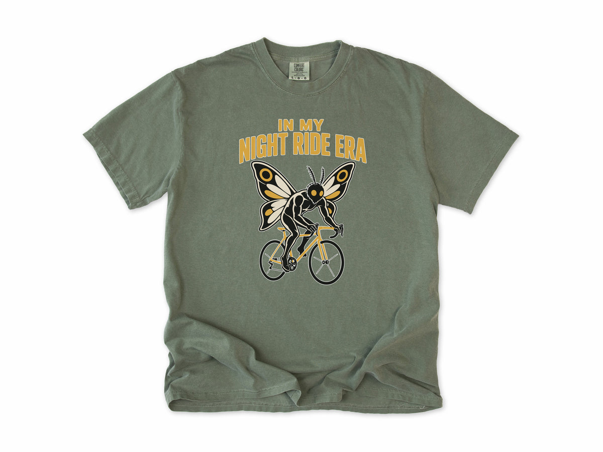 Funny cycling T-shirt in Moss, Mothman Single: 'In my night ride era', a moth-winged figure riding a bike, for night riders