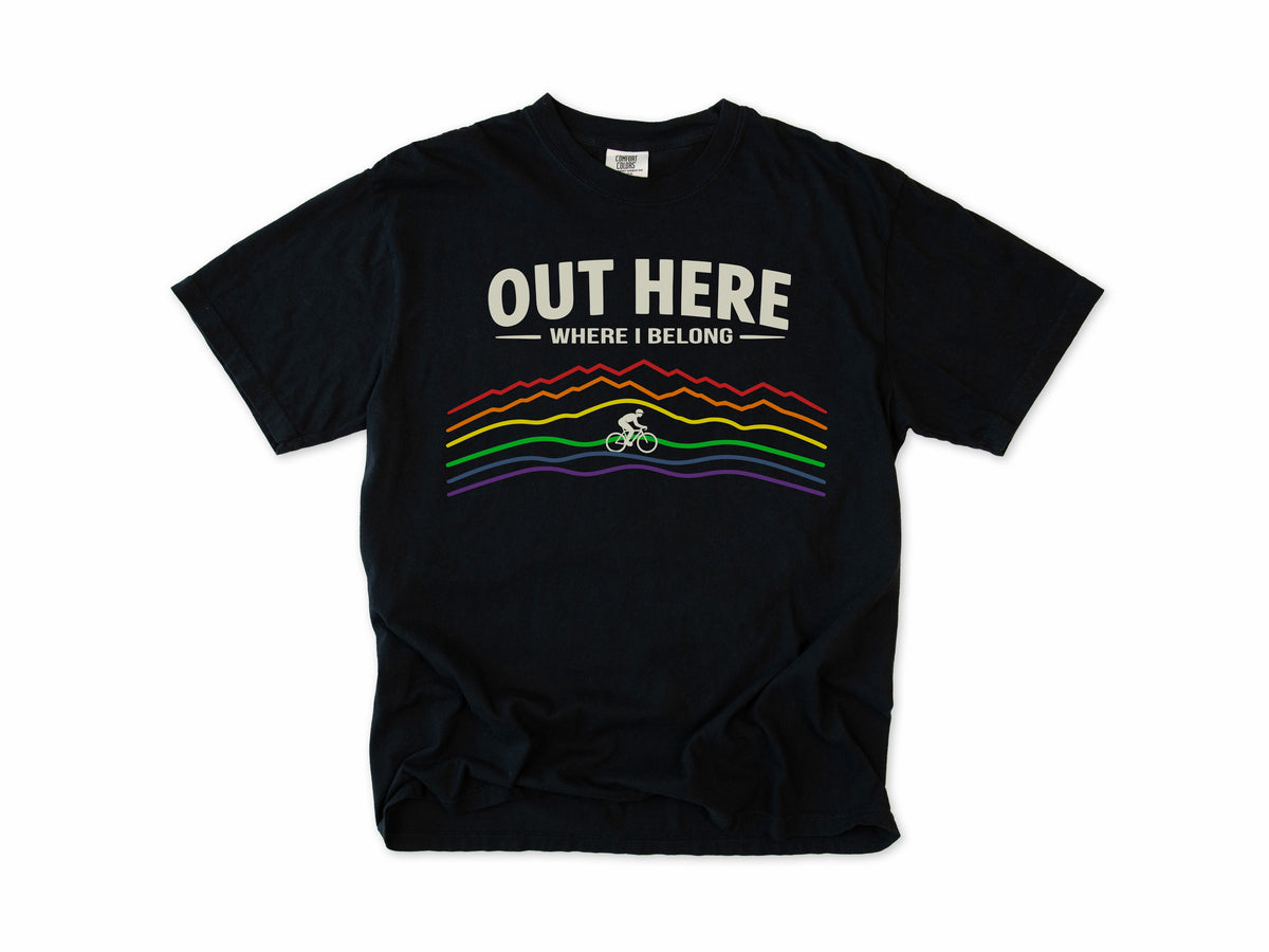 Cycling T-shirt in Black, 'Out Here Where I Belong' with rainbow mountain lines and a cyclist, for outdoor cyclists