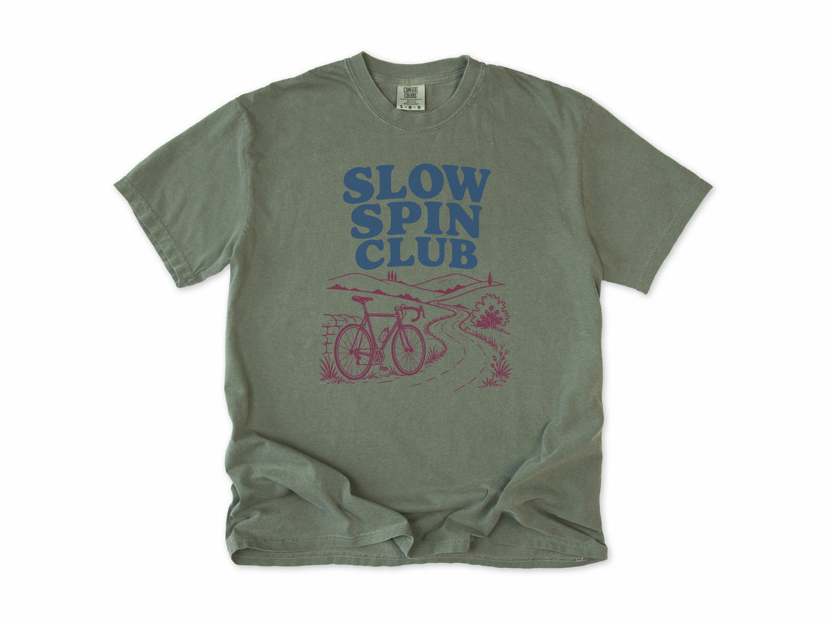 Cycling T-shirt in Moss, 'Slow Spin Club' with a bike on a winding country lane, for relaxed riders