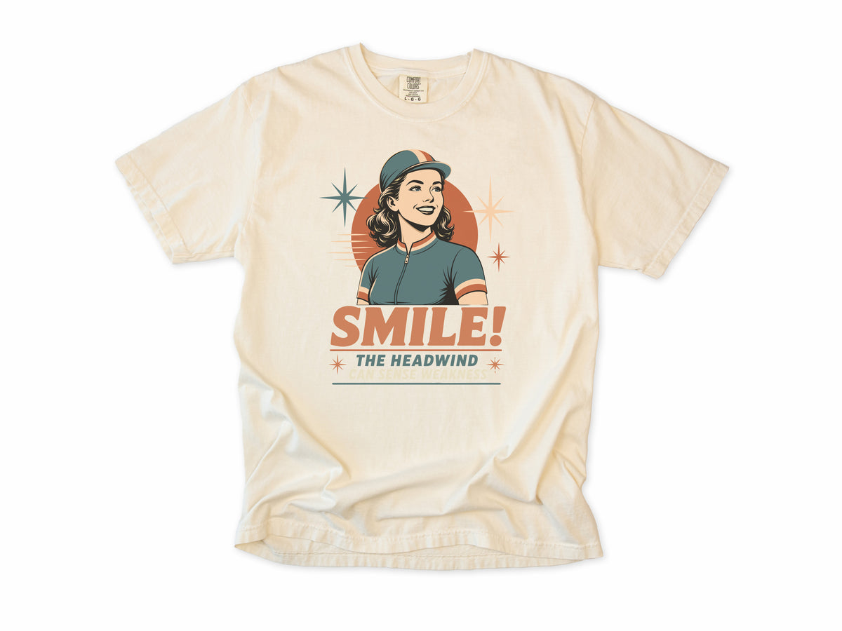 Funny cycling T-shirt in Ivory, a retro woman cyclist in a cap, 'Smile!', gift for a woman who cycles: mum, wife, sister, daughter, nan