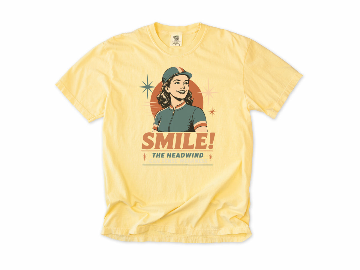 Funny cycling T-shirt in Butter, a retro woman cyclist in a cap, 'Smile!', gift for a woman who cycles: mum, wife, sister, daughter, nan