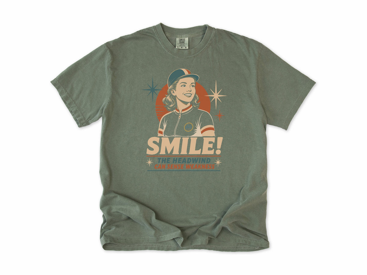 Funny cycling T-shirt in Moss, a retro woman cyclist in a cap, 'Smile!', gift for a woman who cycles: mum, wife, sister, daughter, nan